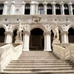 Staircase leading to ornate historical building entrance.