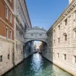 Bridge over Venice canal in sunlight