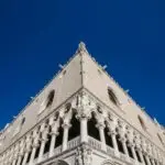 Gothic architecture with blue sky and flying seagulls.