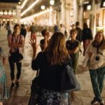 Tour guide talking to group at night