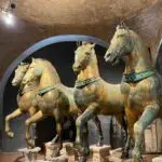 Bronze horse statues in historic museum setting.